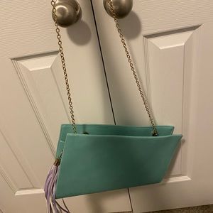 Green clutch with goldlink strap.